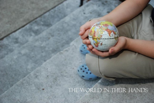 child-holding-globe